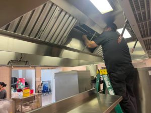 Black Fire & Security Services installing fire protection in restaurant kitchen